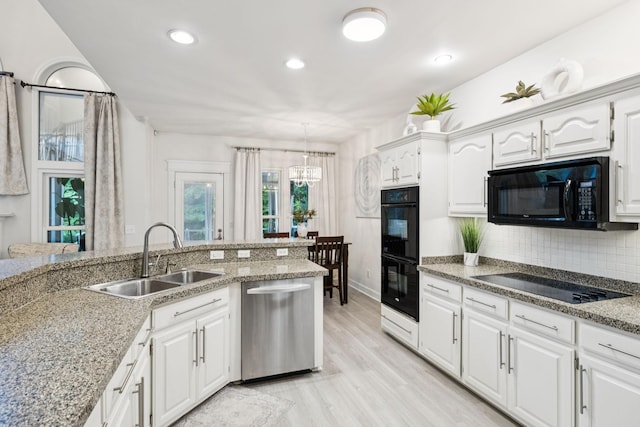 9455 Foothills Ct, Brentwood, TN 37027 - kitchen featuring black appliances, light wood-type flooring, white cabinets, backsplash, and recessed lighting