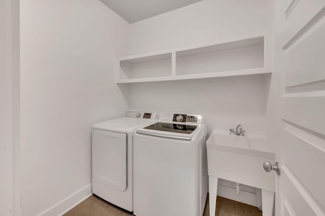 525B Stevenson St, Nashville, TN 37209 - laundry area with washing machine and clothes dryer, light tile patterned floors, and baseboards
