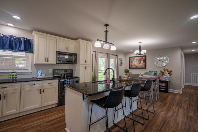 703 Brenda Ave, Loretto, TN 38469 - kitchen featuring black microwave, range with electric stovetop, a sink, a chandelier, and dark wood-style flooring
