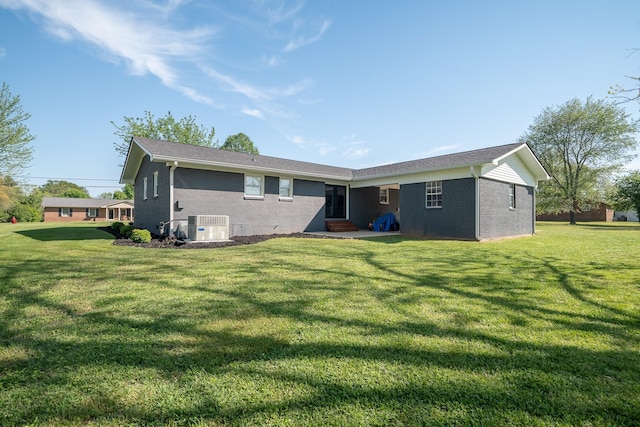 703 Brenda Ave, Loretto, TN 38469 - back of property featuring brick siding, entry steps, a lawn, and central AC unit