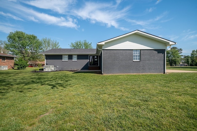 703 Brenda Ave, Loretto, TN 38469 - back of house featuring a lawn and brick siding