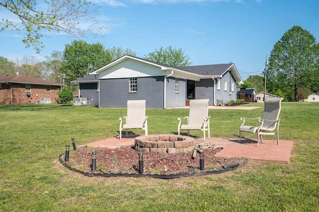 703 Brenda Ave, Loretto, TN 38469 - back of house with an outdoor fire pit, a patio, and a yard