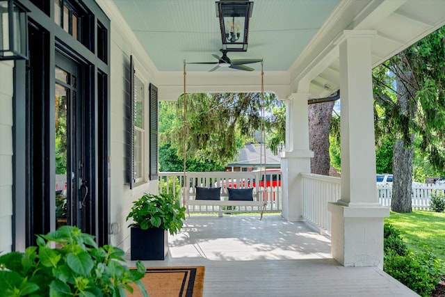 wooden terrace featuring a porch and ceiling fan