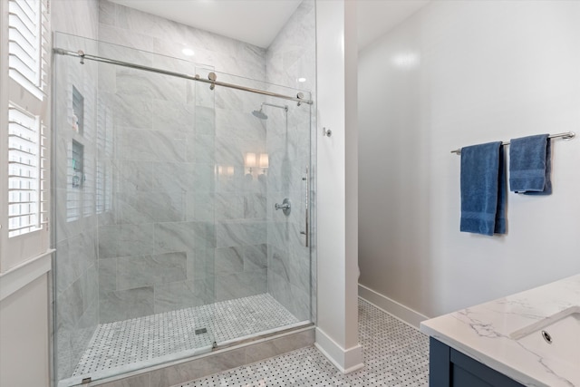 bathroom with a shower stall, baseboards, and vanity
