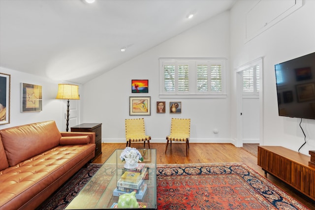 living area with lofted ceiling, light wood finished floors, baseboards, and recessed lighting