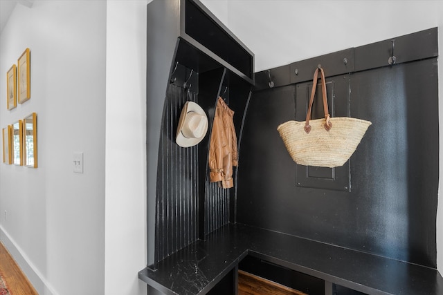 mudroom with wood finished floors and baseboards