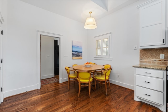 dining room featuring dark wood-type flooring and baseboards