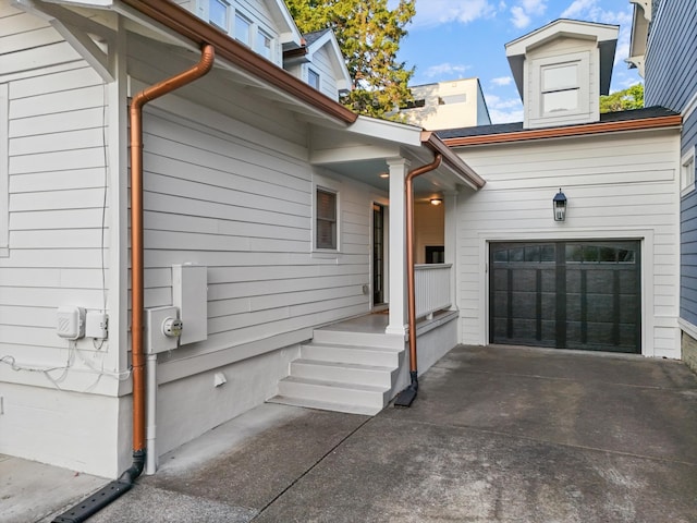 view of side of home featuring concrete driveway and an attached garage