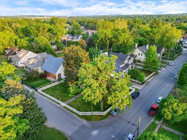 aerial view of residential area featuring a forest