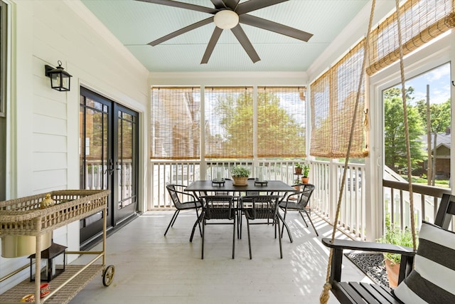 sunroom / solarium featuring ceiling fan and outdoor dining area
