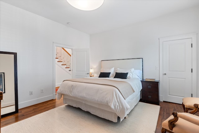 bedroom featuring wood finished floors and baseboards