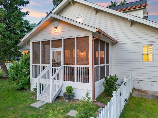 back of property with a sunroom and crawl space