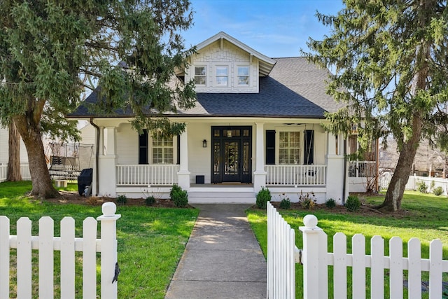 view of front facade featuring covered porch and roof with shingles