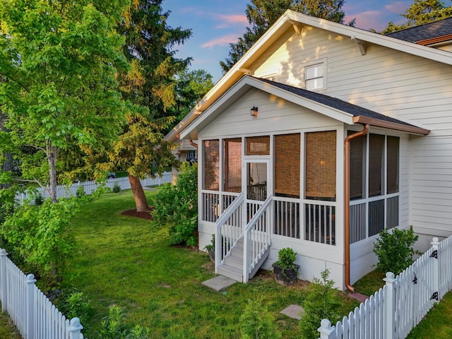 back of property with a sunroom