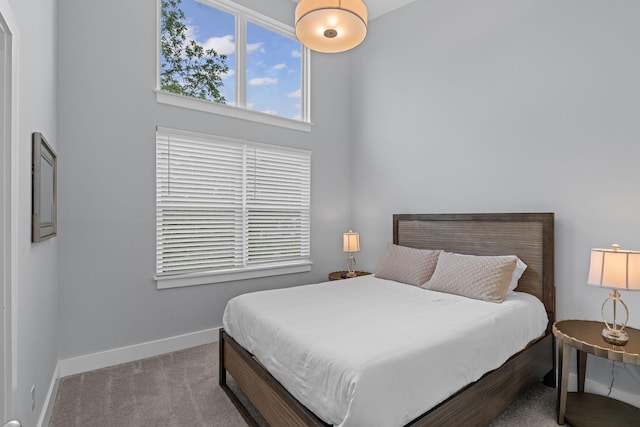 bedroom with baseboards and carpet flooring