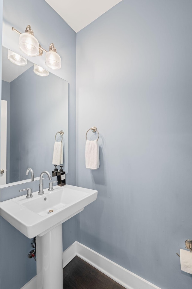 bathroom featuring baseboards and wood finished floors