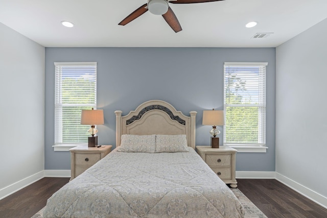 bedroom featuring baseboards, multiple windows, and recessed lighting