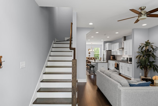 living area with ceiling fan, stairway, recessed lighting, dark wood-style floors, and baseboards