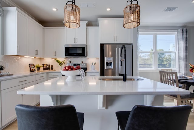 5211 Gladecress Ln, Hermitage, TN 37076 - kitchen featuring appliances with stainless steel finishes, a sink, a kitchen breakfast bar, light countertops, and a kitchen island with sink
