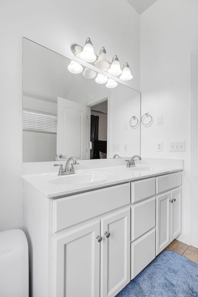 full bath with double vanity, tile patterned flooring, and toilet