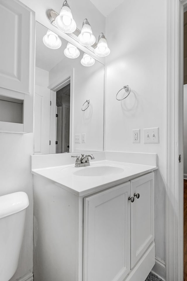 bathroom featuring vanity and toilet
