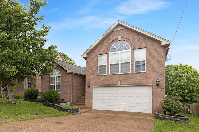 view of front of property featuring brick siding, driveway, a garage, and a front lawn