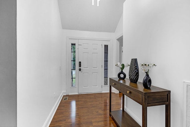 entrance foyer with lofted ceiling, dark wood-style floors, and baseboards