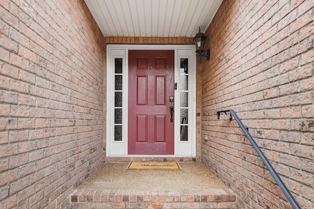 doorway to property featuring brick siding