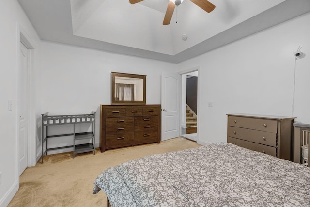 bedroom with light colored carpet, baseboards, and ceiling fan