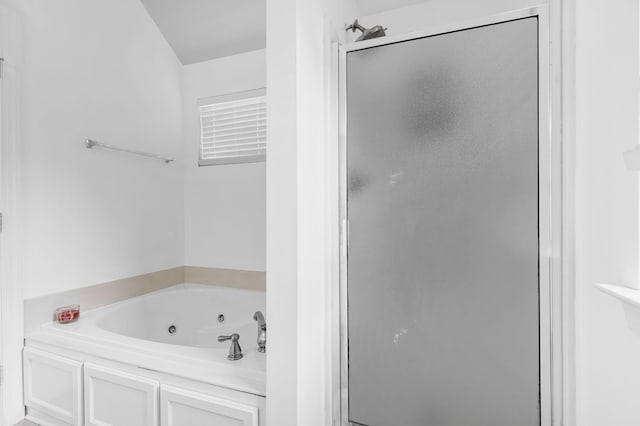 bathroom with a stall shower and a whirlpool tub