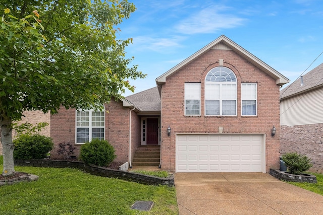 split level home featuring driveway, a front yard, an attached garage, brick siding, and roof with shingles