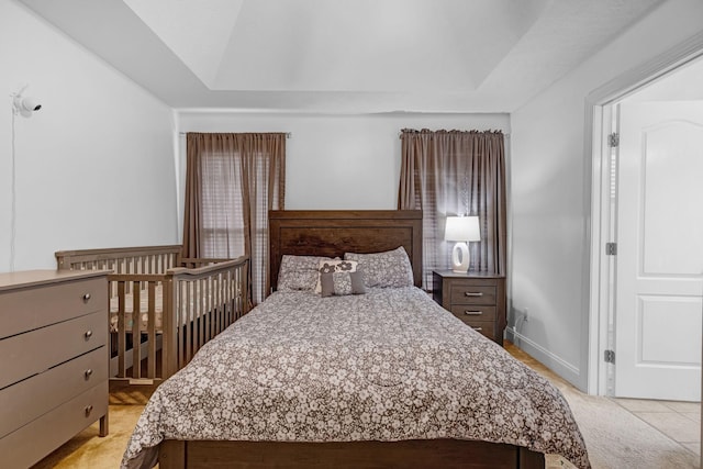 bedroom with light carpet and vaulted ceiling