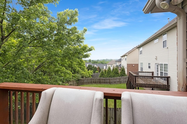 deck featuring a fenced backyard and a residential view