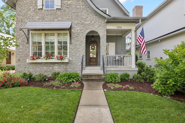 1224 Adams St, Franklin, TN 37064 - property entrance with stone siding, a lawn, and covered porch