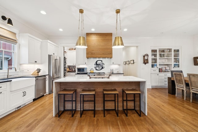 1224 Adams St, Franklin, TN 37064 - kitchen with appliances with stainless steel finishes, a sink, custom exhaust hood, backsplash, and recessed lighting