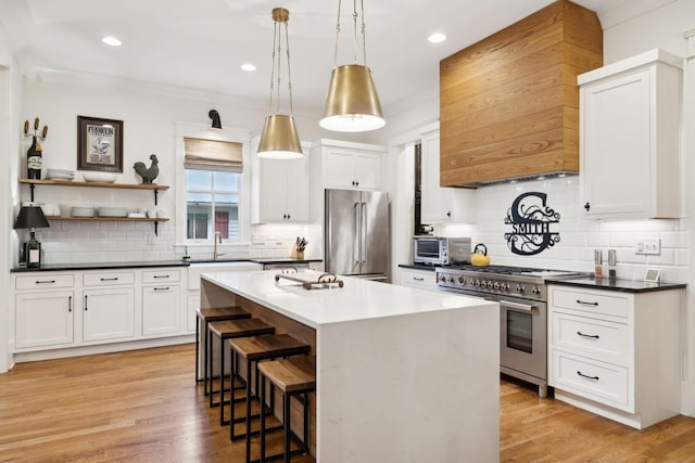 1224 Adams St, Franklin, TN 37064 - kitchen with high quality appliances, a breakfast bar area, backsplash, white cabinetry, and dark countertops