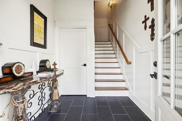 1224 Adams St, Franklin, TN 37064 - foyer entrance featuring a decorative wall, stairs, dark tile patterned flooring, and a wainscoted wall