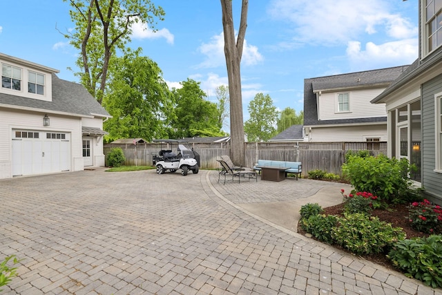 1224 Adams St, Franklin, TN 37064 - view of patio featuring an outdoor living space, fence, and a garage