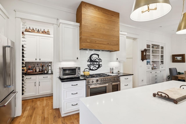 1224 Adams St, Franklin, TN 37064 - kitchen featuring high end appliances, custom range hood, tasteful backsplash, light wood-type flooring, and ornamental molding