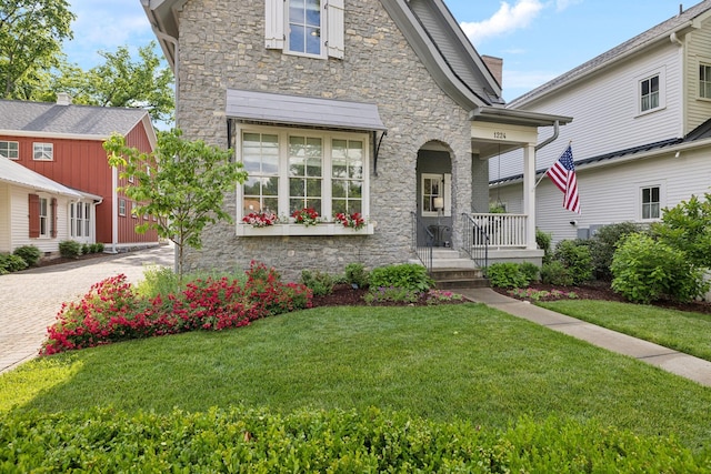 1224 Adams St, Franklin, TN 37064 - view of front facade with stone siding, covered porch, a front yard, and decorative driveway