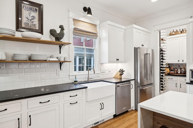 1224 Adams St, Franklin, TN 37064 - kitchen featuring stainless steel appliances, a sink, open shelves, decorative backsplash, and white cabinetry