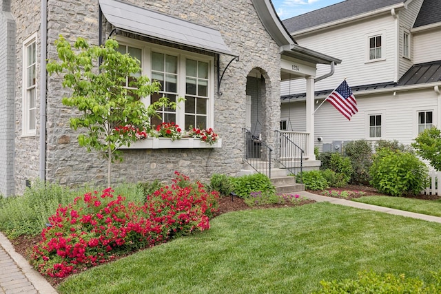 1224 Adams St, Franklin, TN 37064 - view of exterior entry featuring stone siding, a lawn, and a standing seam roof