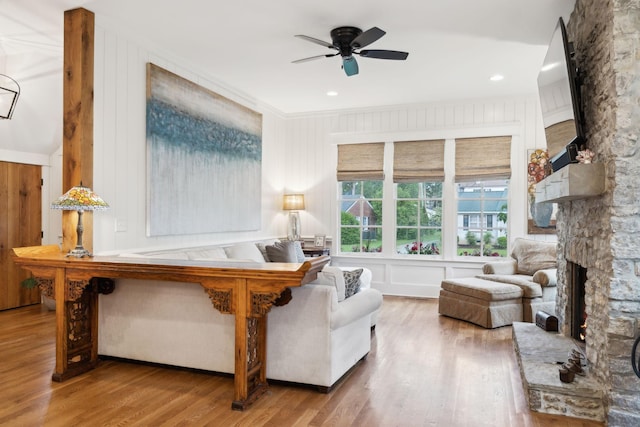 1224 Adams St, Franklin, TN 37064 - living room featuring a ceiling fan, wood finished floors, a fireplace, ornamental molding, and a decorative wall