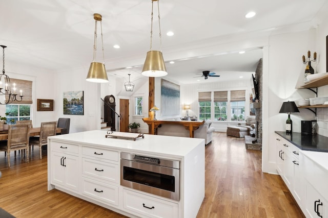 1224 Adams St, Franklin, TN 37064 - kitchen featuring open shelves, open floor plan, crown molding, decorative light fixtures, and white cabinets