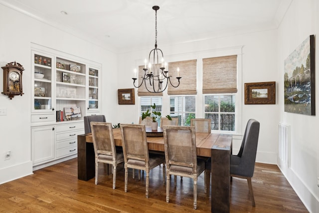 1224 Adams St, Franklin, TN 37064 - dining room with a chandelier, dark wood-style flooring, ornamental molding, and baseboards