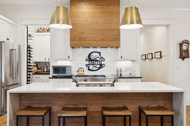 1224 Adams St, Franklin, TN 37064 - kitchen featuring high end refrigerator, decorative backsplash, a breakfast bar area, and white cabinets