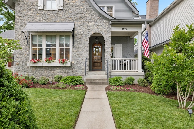 1224 Adams St, Franklin, TN 37064 - view of front of home with stone siding, a front yard, and covered porch