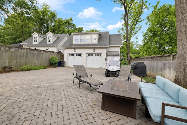 1224 Adams St, Franklin, TN 37064 - view of patio with area for grilling, decorative driveway, an outdoor living space with a fire pit, and a fenced backyard