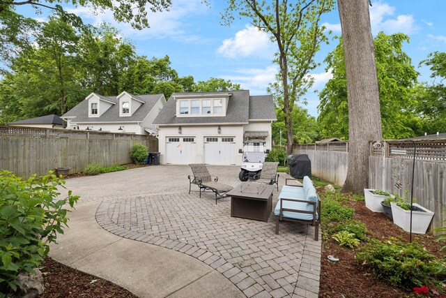 1224 Adams St, Franklin, TN 37064 - view of patio with driveway, a fenced backyard, and an attached garage