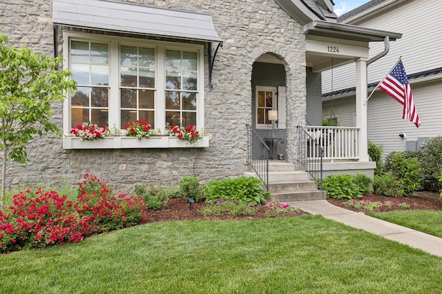 1224 Adams St, Franklin, TN 37064 - property entrance with stone siding, a lawn, and a porch